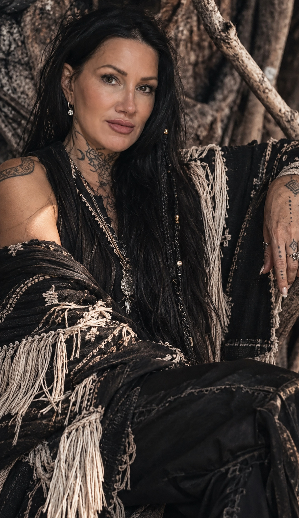 Oriah Hera Mirza seated in a black and cream shawl