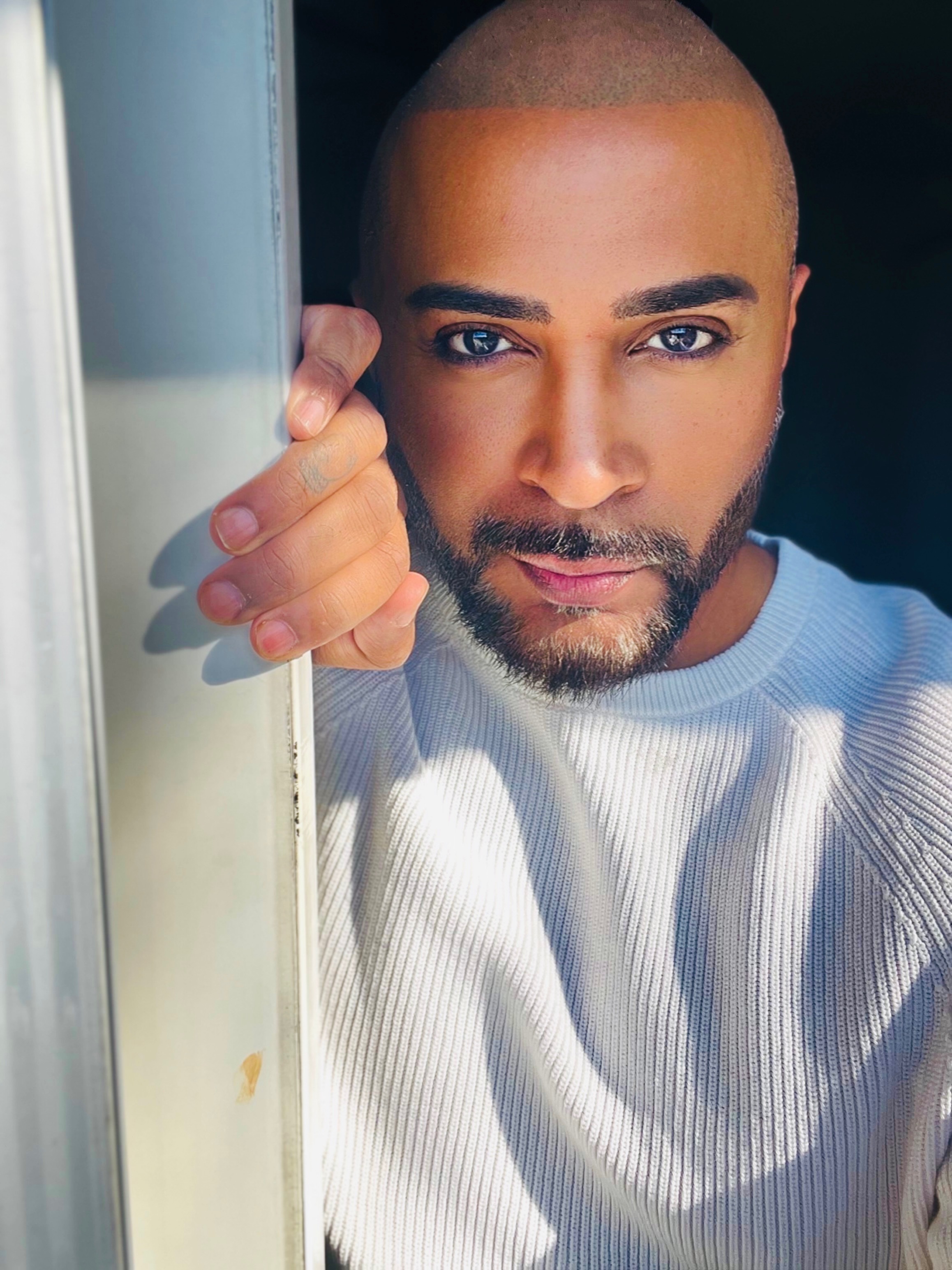 Riz Mirza looking into the camera